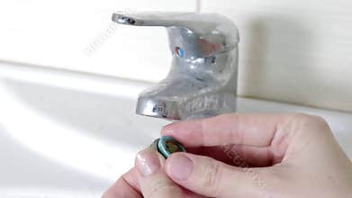 Woman handyman replace tap aerator, hands of a plumber close-up