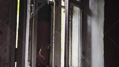 Abandoned building. Close-up of the broken open window.