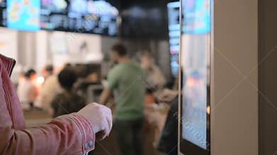 Woman Choosing Food Via Self-Service Machine at Fast Food Restaurant . People Using Self-Service Touch Terminal Makes a