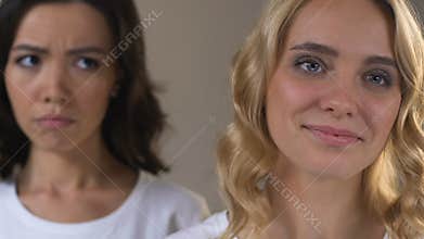 Asian woman is jealous of her caucasian friend who preening before date, rivalry