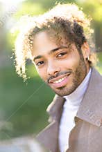 Portrait of afro american smiling man with curly hair.