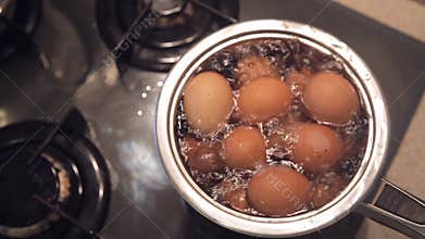 Boiling eggs on a gas stove. Top view close-up