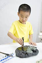 A child learning Chinese Calligraphy