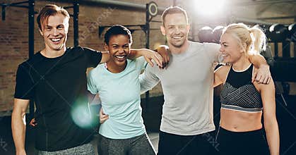 Group of diverse friends laughing while standing in a gym