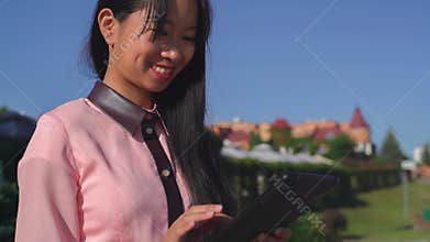 Fashionable lady with gadget outdoors