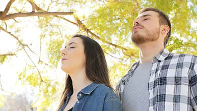 Happy couple breathing fresh air in a park