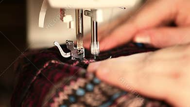 Video Of A Woman Sewing Material On An Electric Sewing Machine