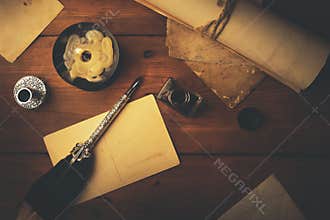 Vintage stationery on wooden table in candlelight