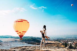 Couple in love among balloons. A guy proposes to a girl. Couple in love in Pamukkale. Couple in Turkey. Honeymoon in the mountains