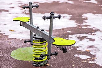Frozen seesaw outdoors in a playground