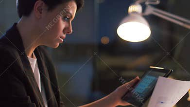 Ui designer with tablet pc working at night office