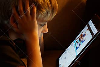 Boy staring at iPad tablet computer