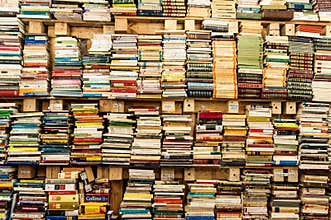 Piles of poetry and narrative books in old library