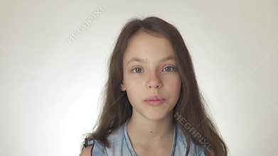Beautiful happy teenage girl looks and is surprised close-up on white background stock footage video