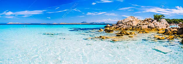Clear amazing azure coloured sea water with granite rocks in Capriccioli beach, Sardinia, Italy