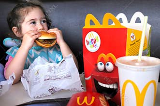 Little girl eats fast food