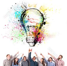 Brainstorming concept with businessmen that indicate an a lamp. Concept of idea and company startup