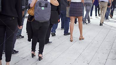 PARIS, FRANCE- CIRCA August 2017: Legs of people walking and standing in line outside. Business people in queue in