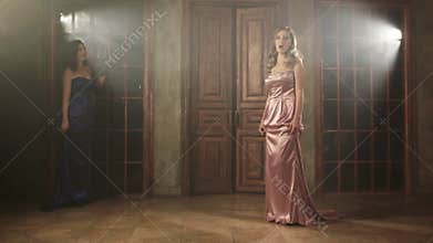 Two beautiful opera singers in long dresses