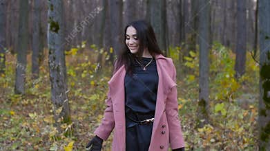 Young happy Woman Throwing Autumn Leaves
