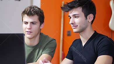 Young men videochatting on laptop PC