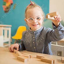 Beautiful girl with down syndrome engaged in class