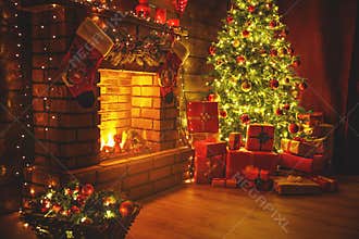 Interior christmas. Magic glowing tree, fireplace gifts in dark