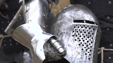 Knights carry a helmet in his hand