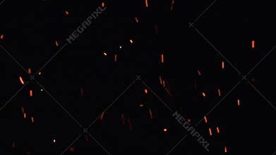 Ultra slow motion shot of fire flames and glowing ashes on black background