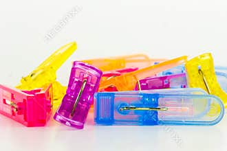 Group plastic colorful clothespin on white background. Home related object.