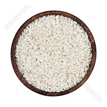 Risotto rice in wooden bowl isolated on white background. Top view