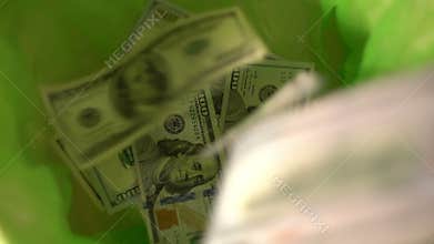 Throwing money away, dollars Fall in green Trash Can basket, freedom from finance, wasting money