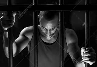 African American man behind bars