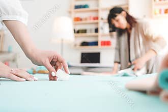 Group of two seamstress work in sewing studio. Small business. Blur background