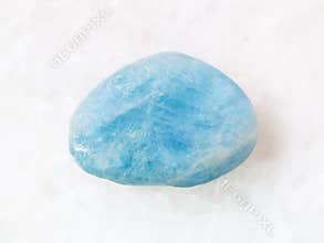tumbled aquamarine (blue beryl) gem stone on white