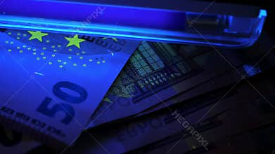 Euro under ultraviolet light. Detecting fake banknotes.