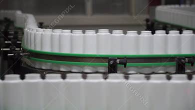 Factory and research concept. Clip. Bottles moving on manufacturing line. Bottles in line on conveyor belt. Production