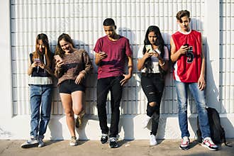 Diverse teenagers with their mobile phones
