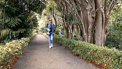 Woman walk at the botanical garden park