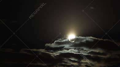 Thick cumulus clouds hiding full moon at midnight, mysterious sky, astronomy