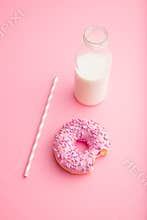 Pink donut and milk bottle.