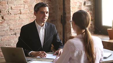 Friendly employer handshaking welcoming hired employee after successful job interview
