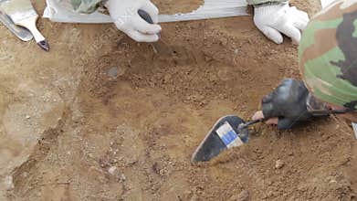 Joint work of two archaeologists during the excavations of the medieval tomb