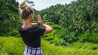 Female meditating on Tegalalang Rice Terrace, Ubud, Bali, Indonesia