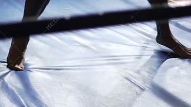 Feet of active Muay Thai fighter training, practicing knee strikes, martial arts