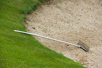 Rake in golf bunker