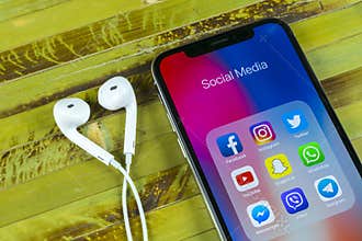 Apple iPhone X with icons of social media facebook, instagram, twitter, snapchat application on screen. Social media icons. Social