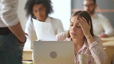 Sad frustrated businesswoman gets document with bad news, dismissal notice