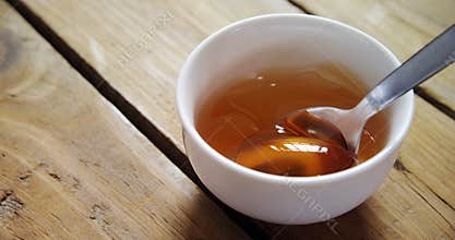 Bowl of honey with spoon 4k