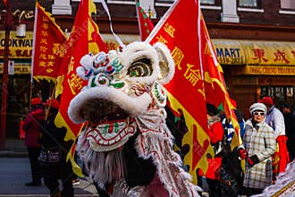 VANCOUVER, CANADA - February 18, 2014: People in White Lion Costume at Chinese New Year parade in Vancouver Chinatown.